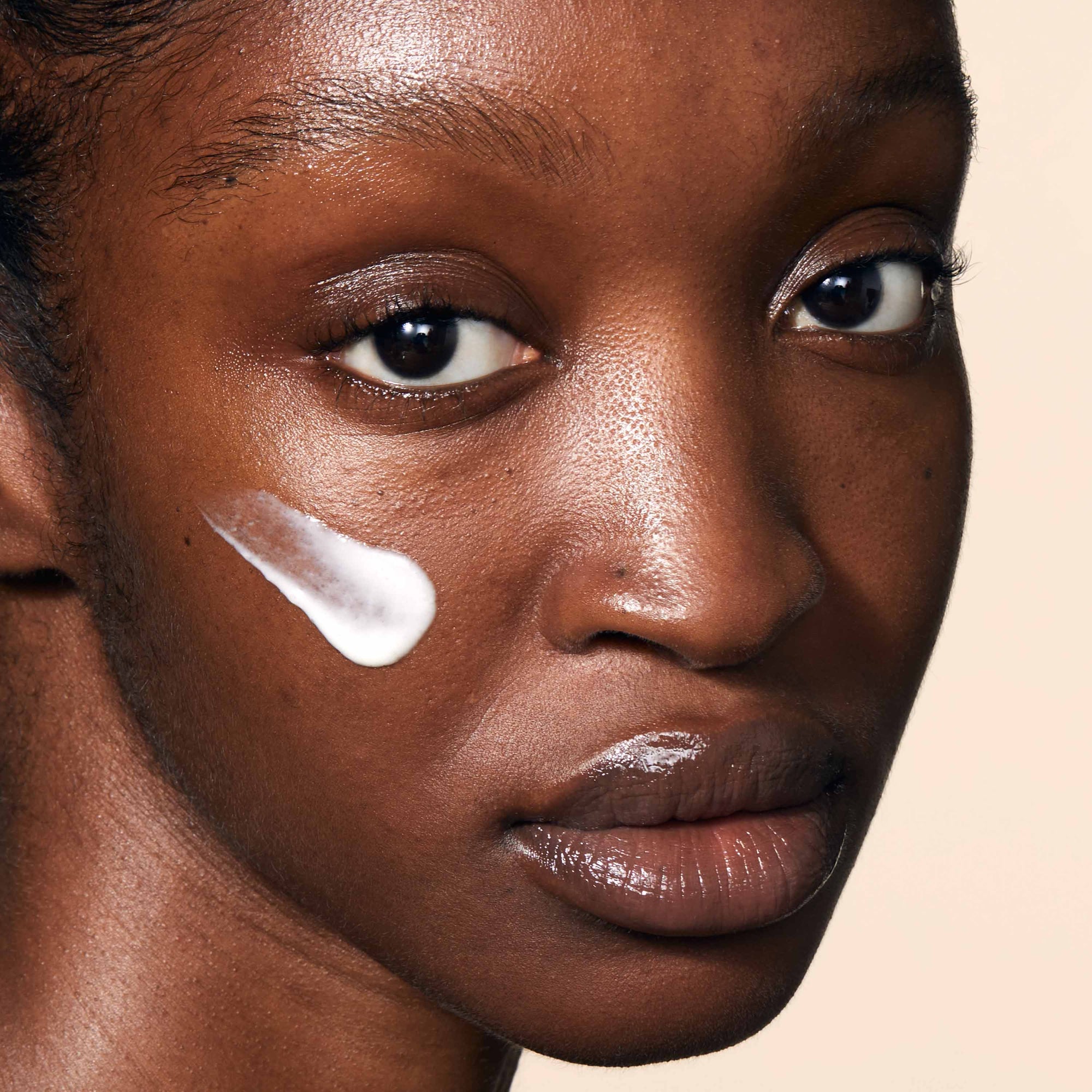 A close up of model's face with Balancing Moisturiser applied to her skin.