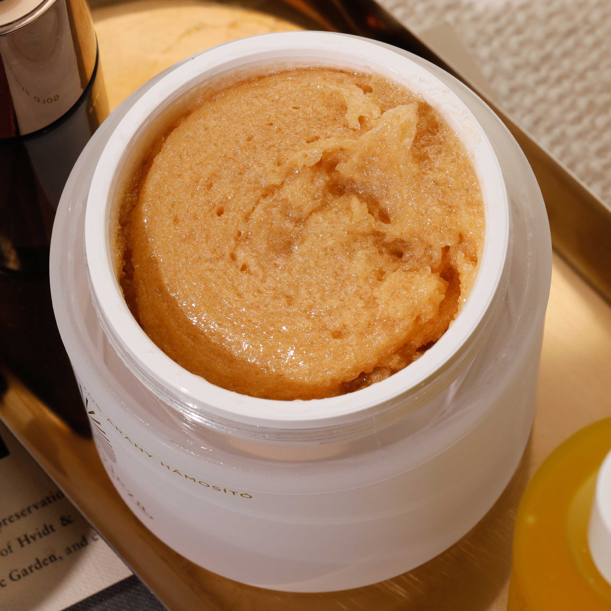 Gold Sugar Scrub in a pot, has rich and thick texture.