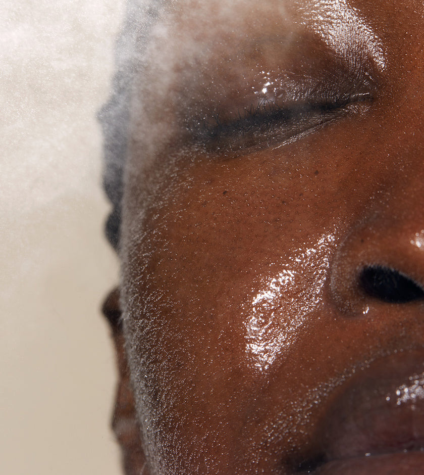 A close up of models face with Queen of Hungary Evening Mist applied to her face. The mist is designed to lock in essential moisture to protect and repair the skin while sleeping
