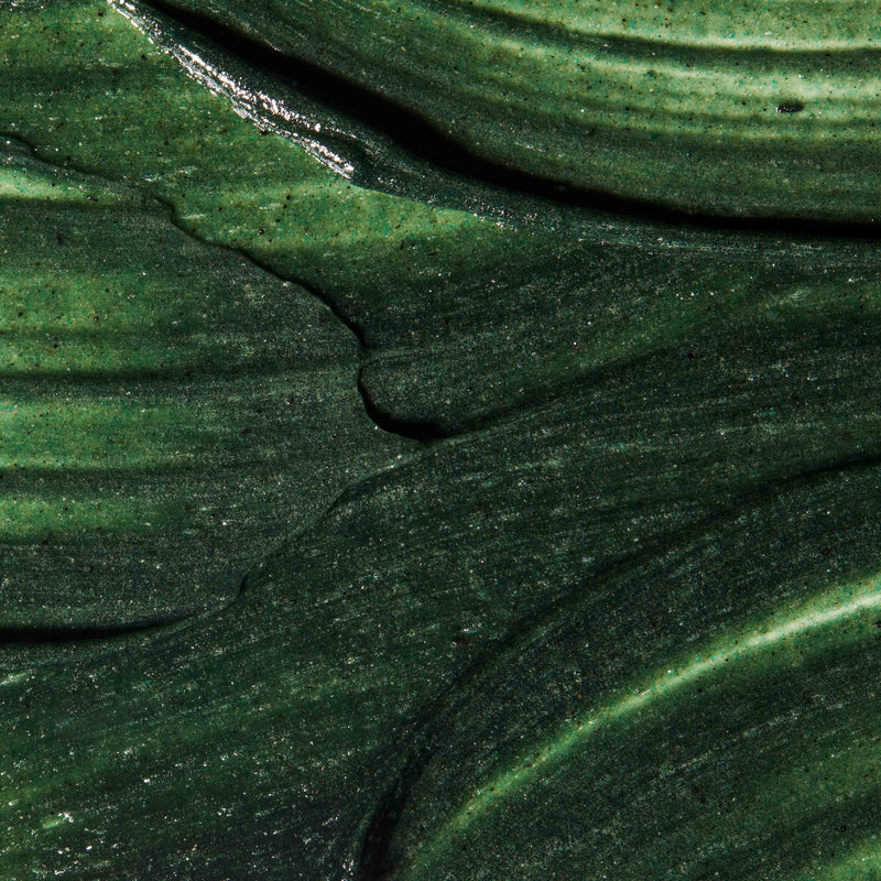 A close up of Refining Facial Polisher texture. Physical exfoliator has deep green colour.