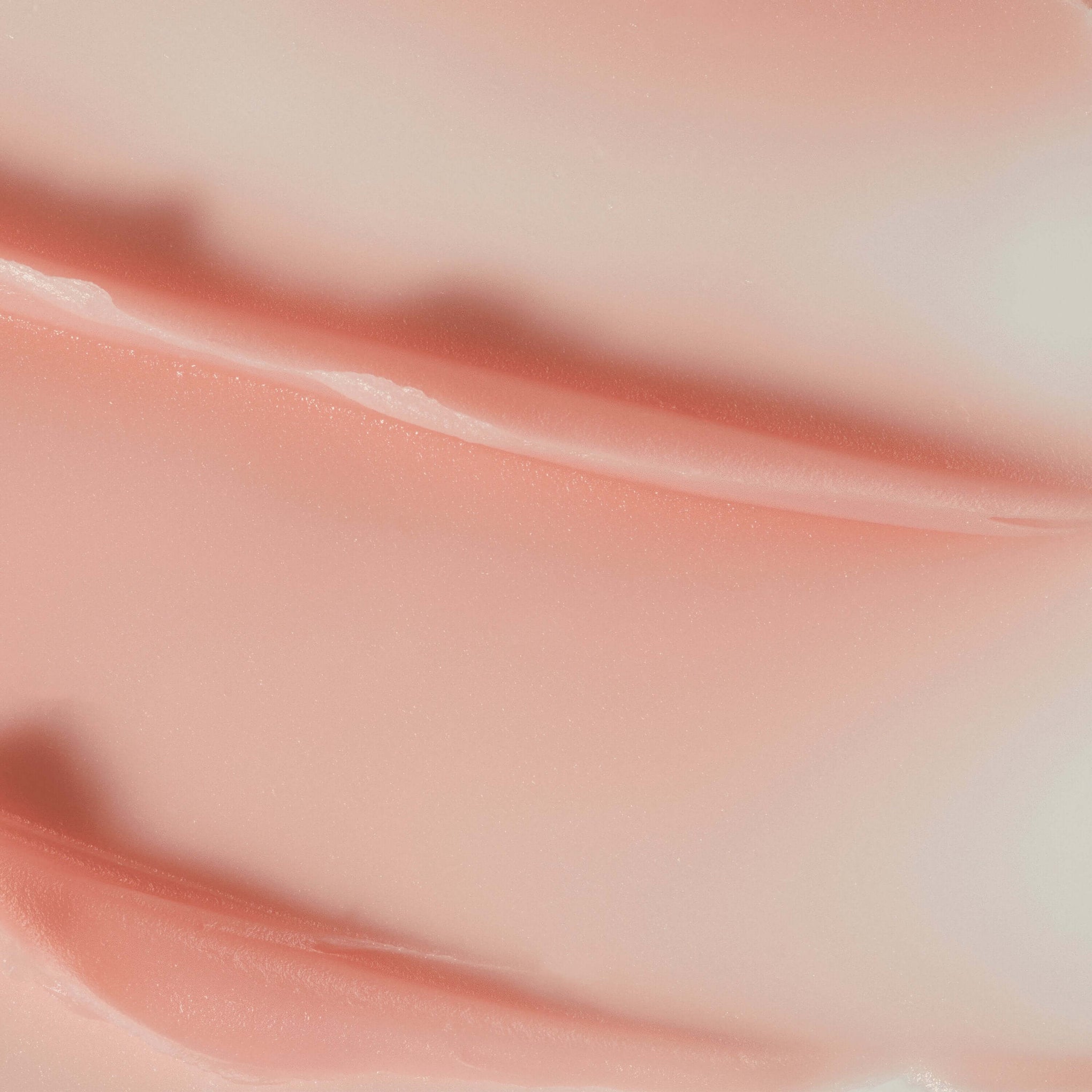 A close up of Perfecting Lip Balm light texture with a light pink colour. 